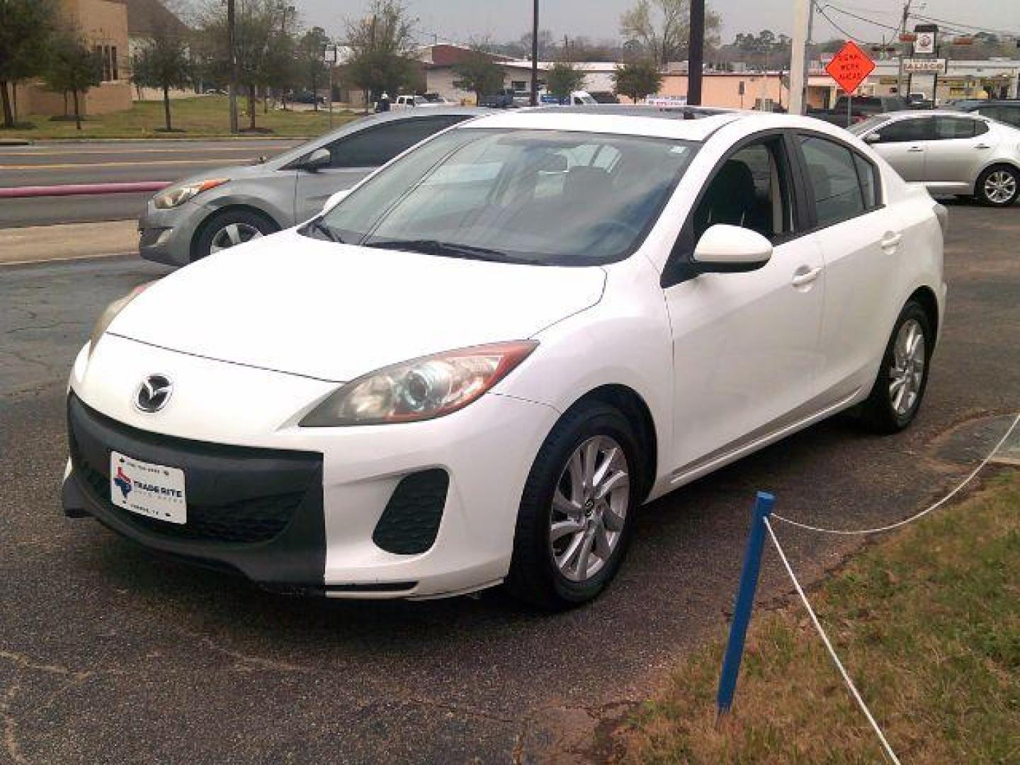 2013 Crystal White Pearl Mica /Dune Mazda Mazda3 i Touring (JM1BL1VP6D1) with an SKYACTIV-G 2L I-4 gasoline direct injection engine, 5-Speed Automatic transmission, located at 116 N. Frazier Street, Conroe, TX, 77301, (936) 647-0690, 30.308662, -95.460480 - Photo#2