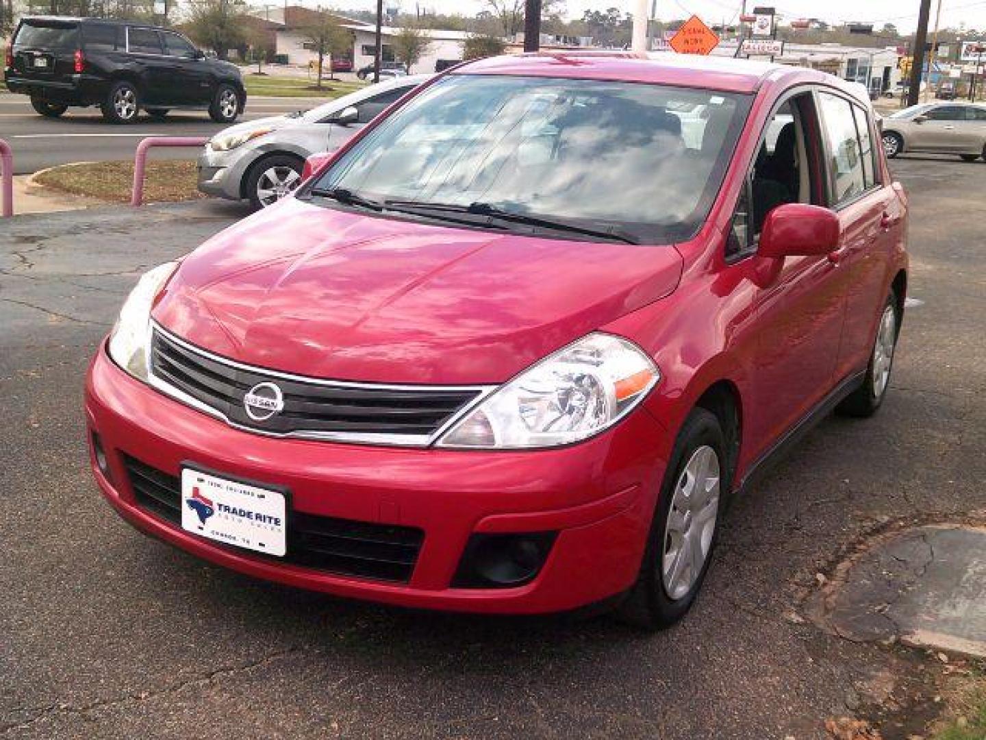 2012 Red Alert Metallic /Charcoal Nissan Versa 1.8 S (3N1BC1CP8CL) with an 1.8L I-4 DOHC engine, 5-Speed Automatic transmission, located at 116 N. Frazier Street, Conroe, TX, 77301, (936) 647-0690, 30.308662, -95.460480 - Photo#2
